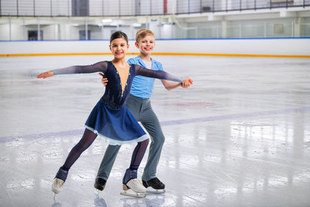 Young figure skaters in elegant ice dance - sports couples at competition, isolated on white background.の写真素材