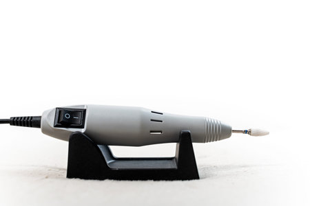 Electric manicure machine with a drill bit on a stand. Portable nail drilling tool for professional...