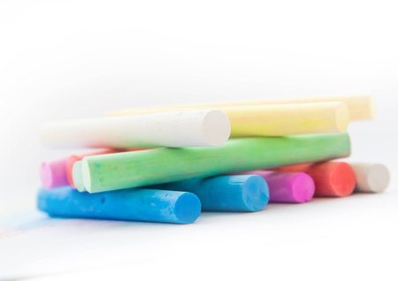 Chalk for drawing colorful on a white background. Chalk in the form of sticks of different colors on the background of the pattern with the same chalk. Chalk pastel colors, not very bright and have a small texture.の写真素材