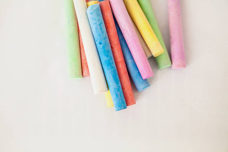 Chalk colorful multicolored on white background, set on top of the background.