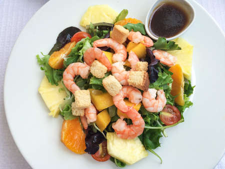 salad with shrimps, cherry tomatoes, thinly sliced ââpineapple, orange, peaches, croutons, lettuce. Lisbon, Portugalの写真素材