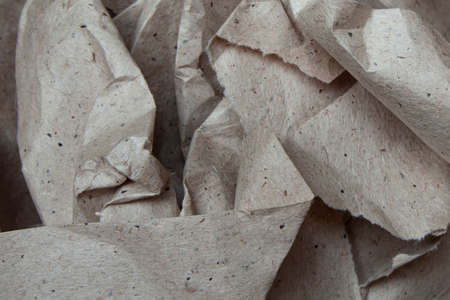 Nicely laid kraft paper. Background texture of old crumpled paper. Packaging process. Gift shop....