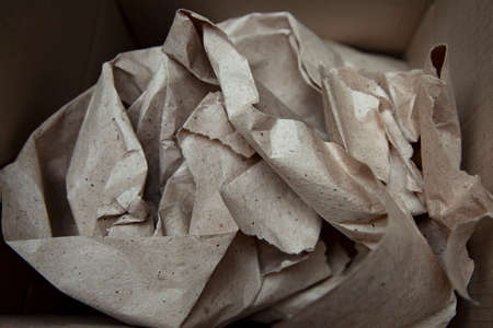Nicely laid kraft paper. Background texture of old crumpled paper. Packaging process. Gift shop. Materials for transportation and shipment. Paper recyclingの写真素材