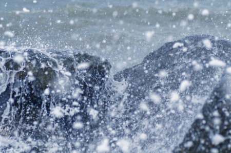 Storm on the coast. The waves hit the rocks and create foam.の写真素材