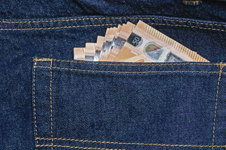 Money in the pocket of blue jeans. close-up. business backgroundの写真素材