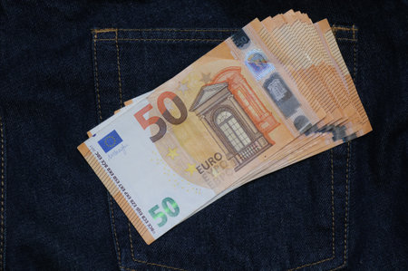 Euro banknotes in the pocket of blue jeans, close-upの写真素材