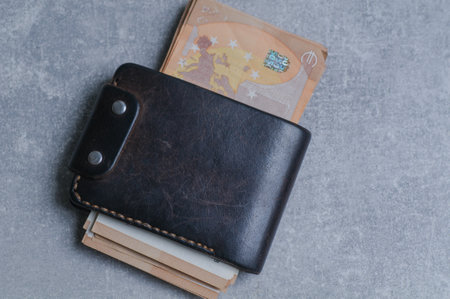 Wallet with money on a gray background. The concept of saving money.