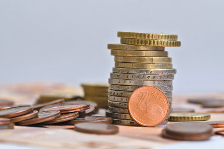 Euro coins on the background of bills and coins of different denominations.の写真素材