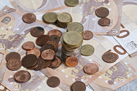 Euro coins and banknotes on a light background close-up.