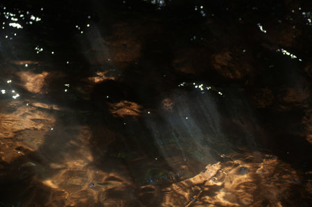 abstract background of water ripples in the river on a dark backgroundの写真素材