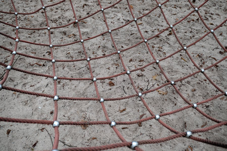 Close up of a net on a playground in a public park.