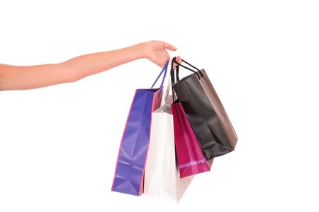 Hand holding a shopping bags over a white backgroundの写真素材