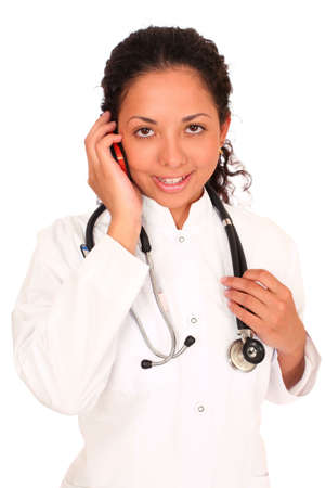 smiling doctor  calling by phone over white backgroundの写真素材