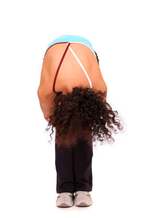 A young sportswoman doing exercise over white backgroundの写真素材