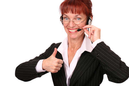 A businesswoman wearing earphones over white backgroundの写真素材
