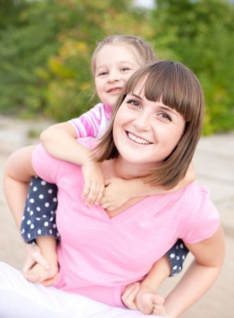 Portrait of happy young mother and daughter.の写真素材