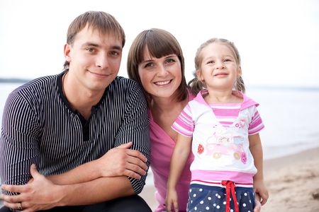 Portrait of happy family on the beachの写真素材
