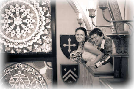 Happy bride and groom on the balcony in palace interiorの写真素材
