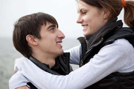 An attractive young woman embracing her handsome boyfriendの写真素材