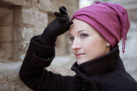 Portrait of a stylish woman near the brick wallの写真素材