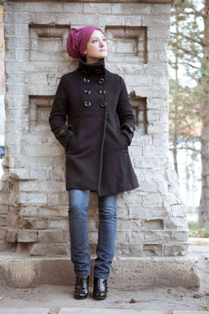 Stylish woman near the brick wallの写真素材