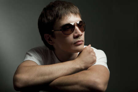 Dark portrait of a young man in sunglassesの写真素材