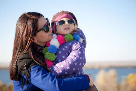 Stylish mother and daughter in outdoorの写真素材