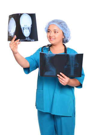 Smiling asian doctor looking at an xray over white backgroundの写真素材