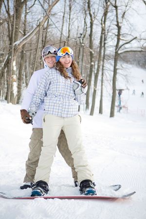 Happy couple of snowboardersの写真素材