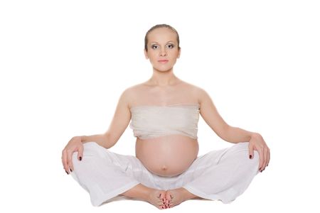 pregnant woman doing exercise over white backgroundの写真素材