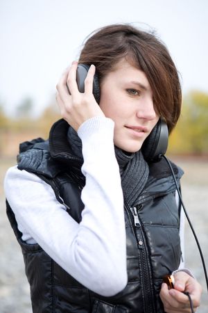 Calm young woman listen to music in outdoors