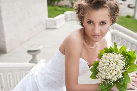 Attractive bride is holding a wedding bouquet の写真素材