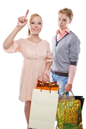 Happy woman and tired man is holding paper bags over white backgroundの写真素材