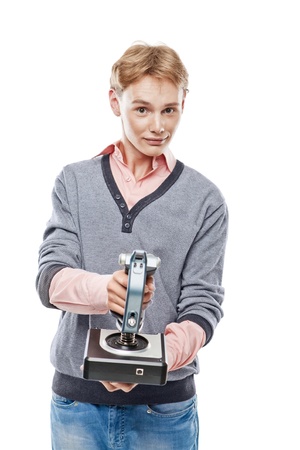 Teenager is holding a joystick and playing computer game over white backgroundの写真素材