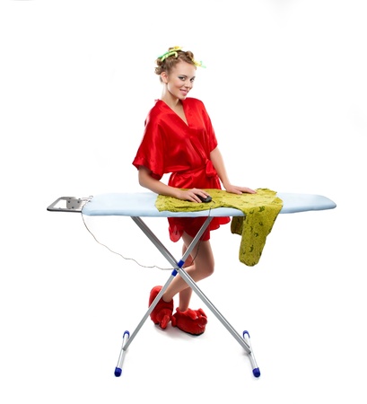 Woman ironing clothes with a computer mouse over white backgroundの写真素材