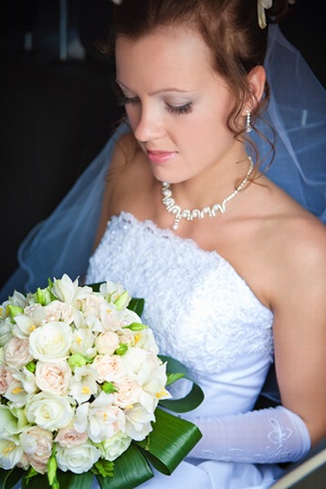 Close-up of a pretty bride with a bouquet of flowersの写真素材