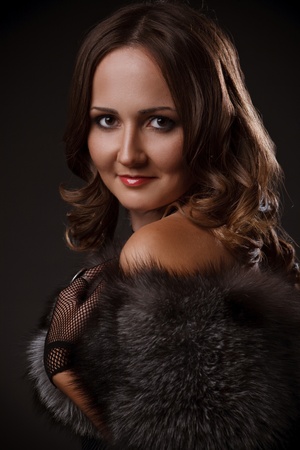 Portrait of a beautiful fashion model smiling wearing dress of fox furの写真素材