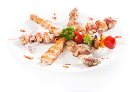 Japanese Cuisine - meat pieces Wrapped in Bacon and grilled vegetables over white background.の写真素材