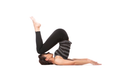 Woman practicing yoga isolated over white backgroundの写真素材