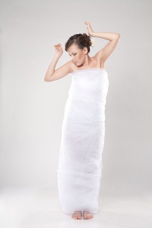 Attractive young woman wrapped in fabricの写真素材