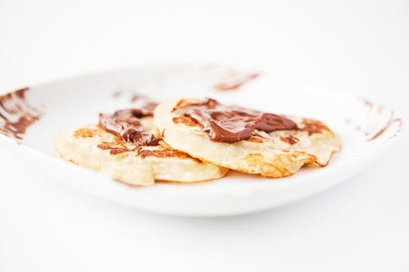 Pancakes with chocolate on the white plateの写真素材