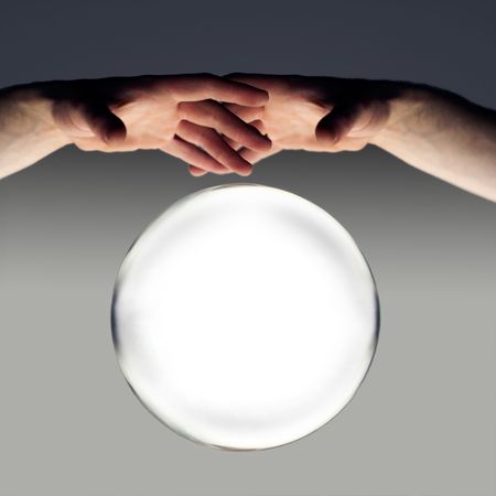 hands over a crystal ball of fortune with a clipping path の写真素材