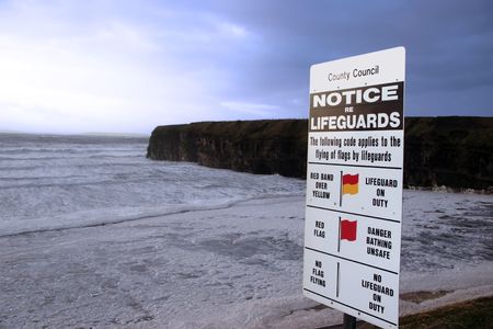 a warning notice on a ballybunion beach in ireland about when lifeguards are on dutyの写真素材