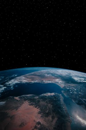 a simple background of the earth and stars at night in the sky of our own universeの写真素材