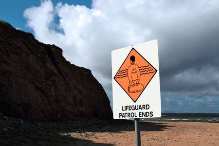 a sign warning that there is no lifeguard patrol beyond this signの写真素材
