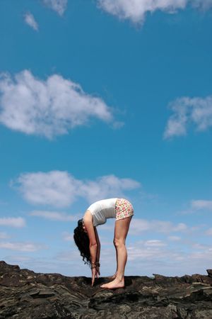 a beautiful woman doing yoga to show a healthy way to live a happy and relaxed lifestyle in a world full of stressの写真素材