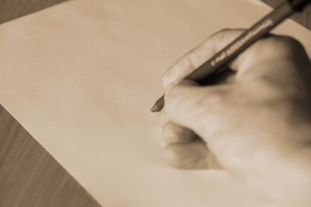 pen in hand about to write on paperの写真素材