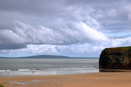 a man walking his digs on ballybunion beach irelandの写真素材