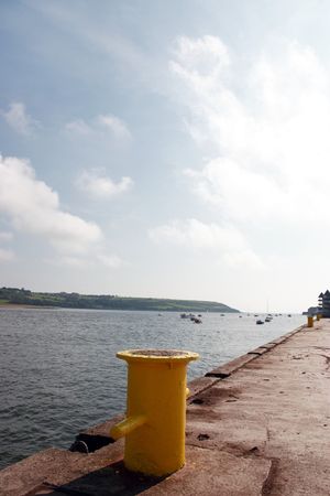 a yellow bollard on an irish quayの写真素材