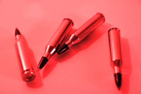 ammunition all in a row on a red background